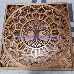 an intricate wooden box with a tree on it