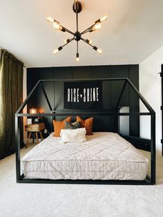 a black and white bedroom with a large bed in the middle, surrounded by lights