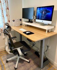 a computer desk with two monitors on it