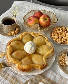 a table topped with pies and bowls filled with fruit