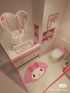 a pink bathroom with hello kitty rug and mirror