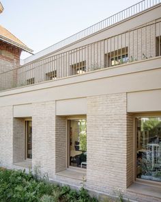 an apartment building with two balconies on the second floor