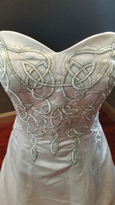 the back of a wedding dress that is on display