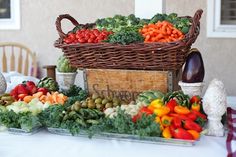 there are many different vegetables in the basket on the table, including peppers and broccoli