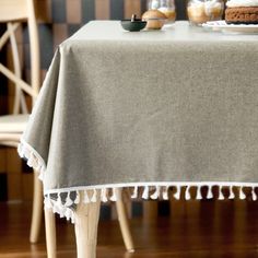 a table topped with a cake next to a wooden chair