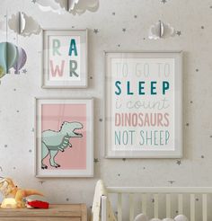 a baby's room with posters on the wall