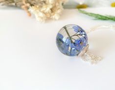 "I have very carefully treated these beautiful blue forget me nots to retain their lovely color then set in crystal clear, eco friendly resin. These lovely little flowers are always a favourite for any flower lover and make the perfect gift to show your undying true love always. Little flowers encapsulated forever and ever... The large orb measures around 25mm, (approx 1\") I have capped with a pretty silver cap, options available the sterling silver chain is 18\" chain or longer 30\" chain for Real Flower Necklace, Remembrance Necklaces, Necklace Resin, Resin Jewelry Diy, Forever And Ever, Forget Me Nots, Silver Caps, Necklace Bridal, Resin Necklace