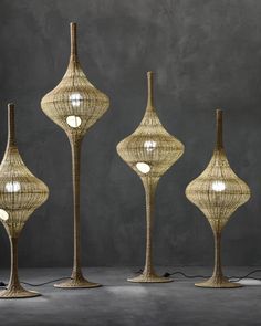 three lamps made out of wicker with lights on each side and one light on the other