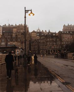 people walking down the street on a rainy day