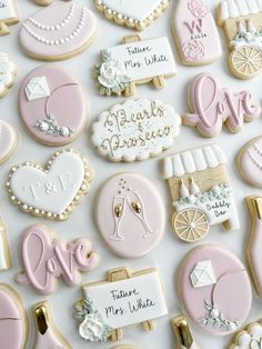 many decorated cookies are displayed on a white surface with the words love, marriage, and other items