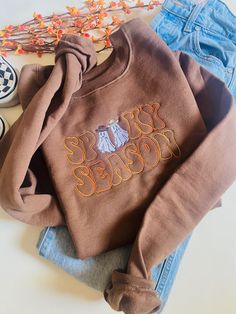 The cutest new edition to the shop! A Spooky Season Western Ghosts Embroidered design on a Hanes Eco Smart/ Gildan Crewneck. Retro Tops With Embroidered Logo For Fall, Trendy Tops With Custom Embroidery For Fall, Retro Embroidered Sweatshirt For Fall, Cute Embroidered Text Tops For Fall, Cute Tops With Embroidered Text For Fall, Cute Custom Embroidered Tops For Fall, Retro Embroidered Graphic Tops For Fall, Cute Tops With Custom Embroidery For Fall, Retro Embroidered Tops For Fall