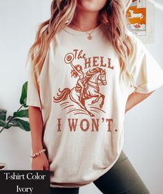 The Hell I Won't  Comfort Colors Shirt | Trendy Western Retro Vintage Graphic Tee | Gift For Country Style Girl | Western Cowgirl Shirts | Country Girl Shirt Comfort Colors introduces its garment-dyed t-shirt; a fully customizable tee made 100% with ring-spun cotton. The soft-washed, garment-dyed fabric brings extra coziness to your wardrobe while the relaxed fit makes it an excellent daily choice. The double-needle stitching throughout the tee makes it highly durable while the lack of side-seam Western T Shirts For Women, Retro Tshirt Design, Western Shirts For Women, Vintage Tshirt Design, Country Girl Shirts, Girl Western, Country Clothing, Funny Shirt Sayings, Cowgirl Shirts