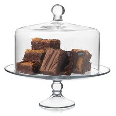 a glass cake dish with four pieces of brownies under it