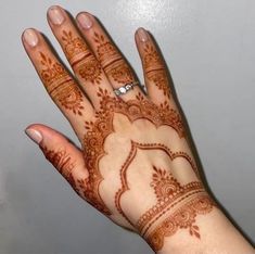 a woman's hand with henna on it