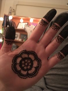 a person's hand with henna tattoos on it