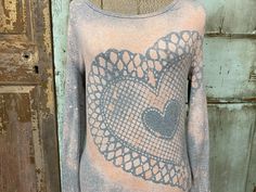 a woman's sweater with an image of a heart on it