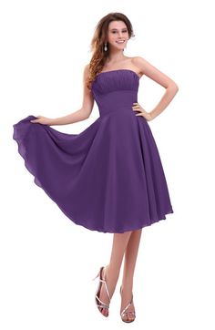 a woman in a purple dress posing for the camera