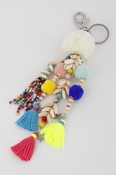 a key chain with tassels and beads on it