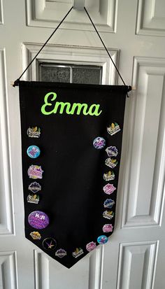 a door with a black banner hanging from it's side that says, emma