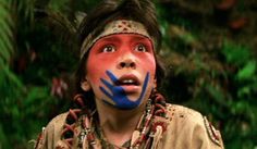 a young man with painted face and headdress