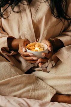 a woman holding a bowl of food in her hands