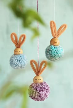 three small stuffed bunnies hanging from strings