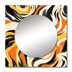 a round mirror sitting on top of a wall next to an orange and black pattern