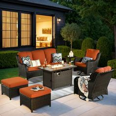 an outdoor living area with furniture and lighting