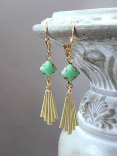 These modern Deco inspired earrings are a great example of classic 1920s style. Perfect for everyday or special occasions.  They feature vintage green glass beads, and stamped brass fan shaped charms. The brass charms have a textured front and a back that is the hollow reverse of the front. (SEE 3rd PHOTO) They are extremely lightweight and comfortable to wear. The earrings measure 2 inches long from the top of the ear wires to the bottom of the pendants. ABOUT THIS COLLECTION What are the three style essentials Jazz Age flappers like Clara Bow, Louise Brooks, and Zelda Fitzgerald have in common? Red lipstick, bobbed haircuts, and fabulous long earrings. My Flapper Collection features stunning Art Deco style dangle earrings for the modern flapper. Green And Gold Art Deco, Green And Gold Art, Bobbed Haircuts, Modern Flapper, Flapper Jewelry, Art Deco Jewelry 1920s, 1920s Earrings, Gold Art Deco Earrings, Zelda Fitzgerald