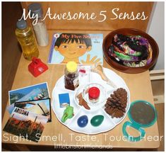 a wooden table topped with lots of different types of food and items to make it look like a child's artwork