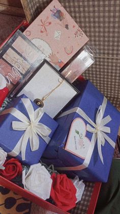 a red and blue box filled with lots of gifts