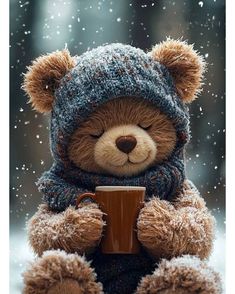 a teddy bear wearing a hat and scarf holding a coffee cup in the snow with it's eyes closed