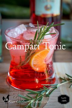 the campari tonic cocktail is garnished with an orange slice and rosemary