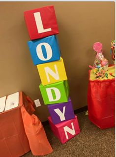 colorful blocks spelling out the word londy next to a red bag with candy on it