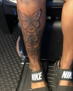 a person with a butterfly tattoo on their leg