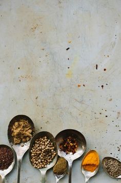 spoons filled with different types of spices