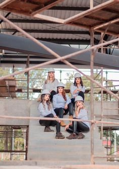 a group of young women sitting on top of stairs