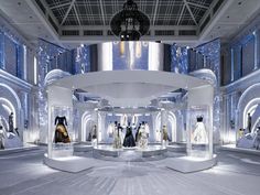 a room filled with lots of mannequins and chandeliers