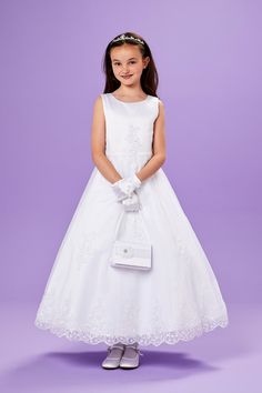 The Erin full length Communion dress is designed in duchess satin with a lace overlay. A sleeveless dress with a round neck, and a row of buttons to the back this dress is a stunning option for your little girl's First Communion day. Finished with splendid embellishments, it's a truly special dress. The dress is fully lined for maximum comfort. Available in White Why not complete the look with our beautiful veils, bags and gloves. The dress is shown with the Beatrice Tiara, Rebecca Glove and Eva Sleeveless Lace Ball Gown With Lace Bodice, Fitted Satin Dress For Confirmation, Satin Fitted Dress For Confirmation, Elegant Sleeveless Gown For Confirmation, White Sleeveless Ball Gown For Confirmation, Lace Ball Gown With Fitted Bodice Sleeveless, Elegant Sleeveless Ball Gown For Confirmation, Sleeveless Lace Bodice Dress For Confirmation, Sleeveless Dress With Lace Bodice For Confirmation