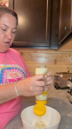 a woman is mixing something in a bowl