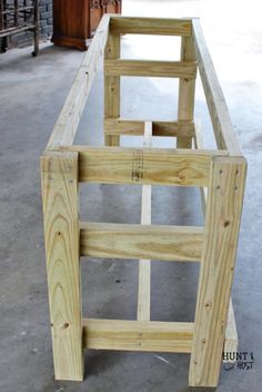 an unfinished bed frame sitting on the floor