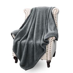 a white chair with a gray blanket on it's back and footrests