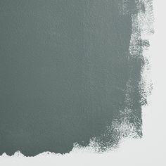 a wall with some paint on it and the color is dark green, which has been painted in shades of gray