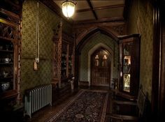 an old fashioned hallway with green wallpaper and ornate woodwork on the walls, along with a radiator