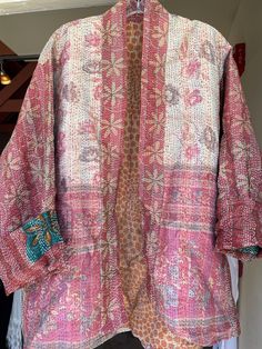 This is silk sari fabric made into kantha shawls and then the coat is made from the scarves. It is a Kimono style, exactly the same measurements as my plus size cotton kantha jackets.  This is one size and will fit anyone from a size 6 up to size 22(2x) Pockets on both sides. In the photos you can see the reverse side. Like having 2 jackets for the price of one.  33 inches long measuring back neck to hem. It measures 54 inches around the bust.  Truly a unique piece of art. I'm a size 8 and it lo Bohemian Long Sleeve Kimono With Chikankari Embroidery, Bohemian Long Outerwear With Chikankari Embroidery, Silk Outerwear With Chikankari Embroidery, Bohemian Silk Kimono For Festive Occasions, Bohemian Long Sleeve Handloom Kurta, Traditional Long Sleeve Block Print Kimono, Long Pink Bohemian Outerwear, Bohemian Long Sleeve Kurta With Dupatta, Festive Bohemian Silk Kimono