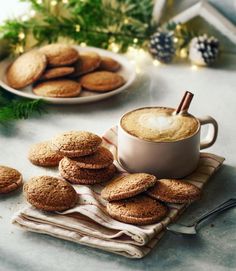 a cup of coffee and some cookies on a table