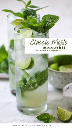 two glasses filled with mojita and limes on top of a marble table