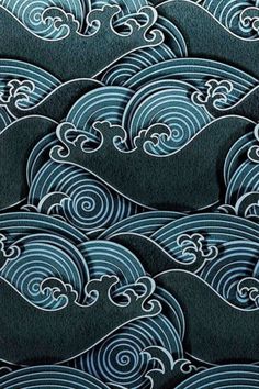 an image of waves in the ocean with blue and white paint on black felt fabric