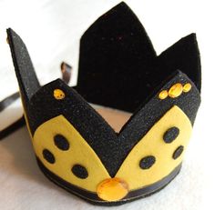 a black and yellow crown sitting on top of a table