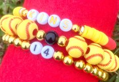 the bracelets are decorated with baseball balls and numbers on them, as well as beads